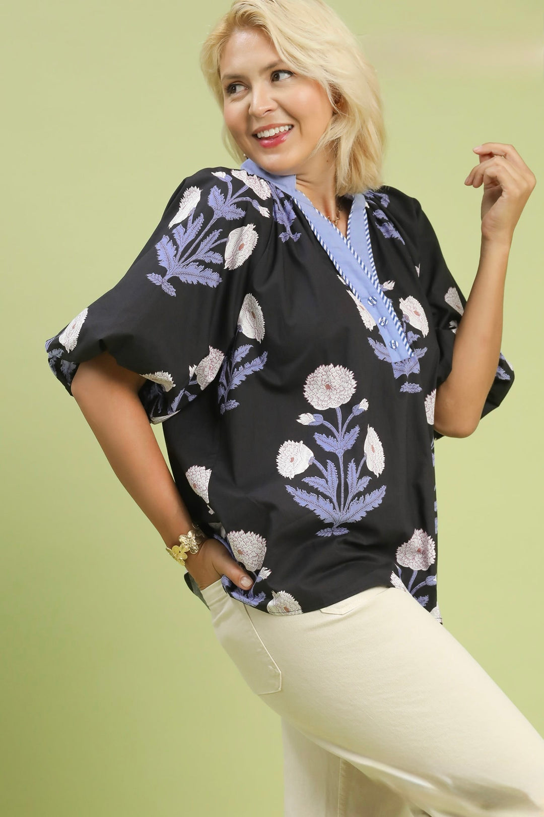 Women's Umgee black top with light blue and cream floral print in plus showing puff sleeve detail.