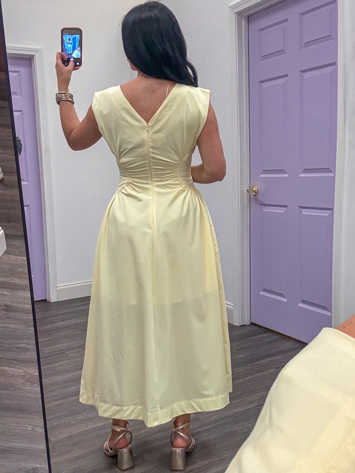 back view of yellow fitted midi dress
