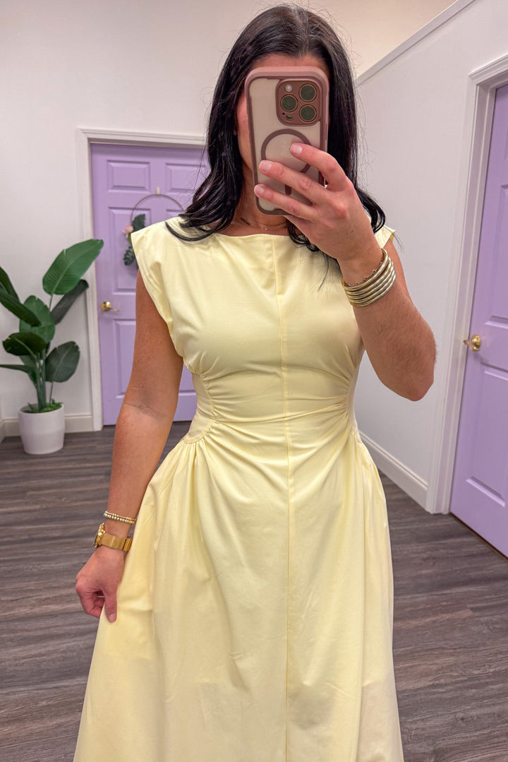 Close up of women's yellow sleeveless midi dress