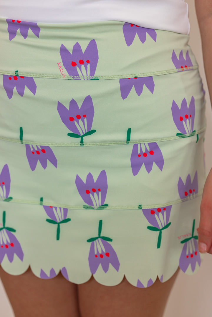 Women's mint green and purple poppy floral print scalloped skort lined with shorts by Karlie showing up close view of floral pattern