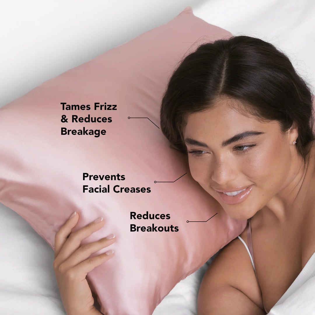 Woman lying on a pink satin pillow