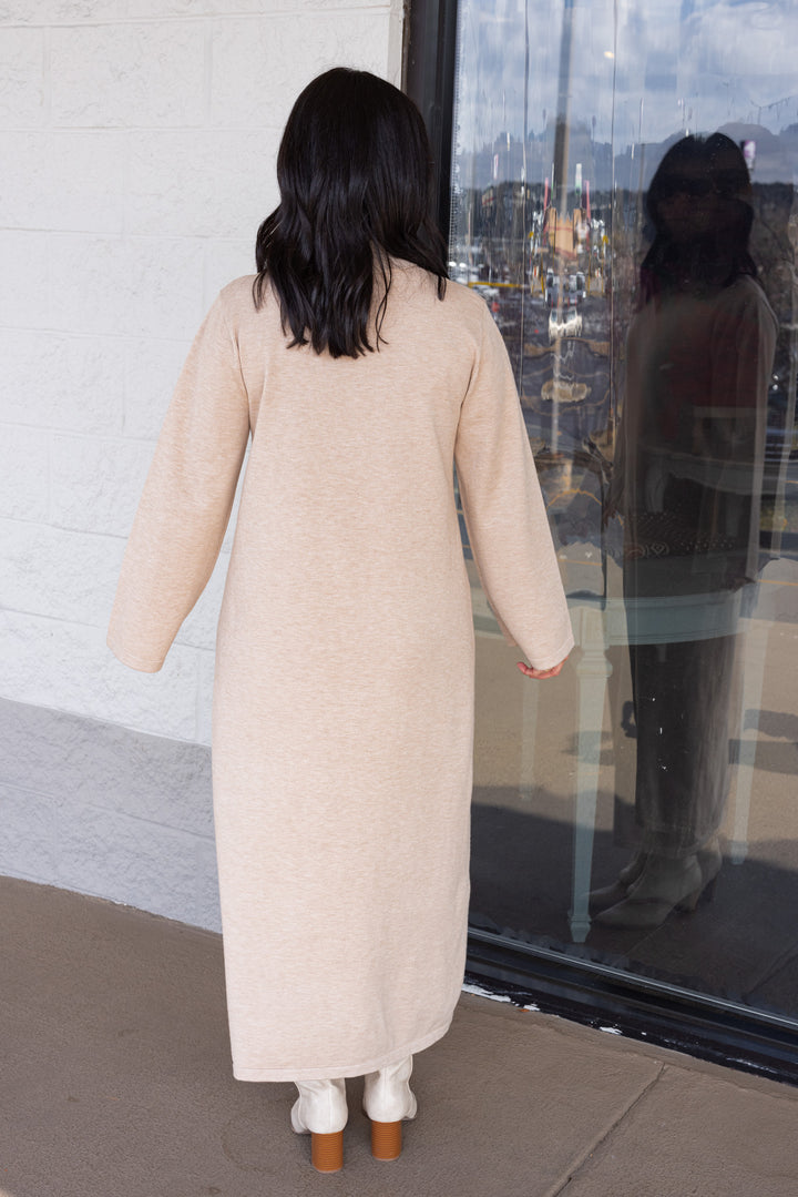 Women's sand beige knit long sleeve midi sweater dress by Entro showing full back view