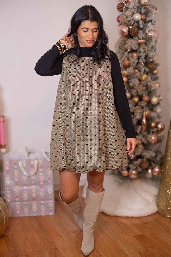 Women's brown, taupe and black gingham bubble hem dress with black bow ties by Glam, perfect for holiday gatherings