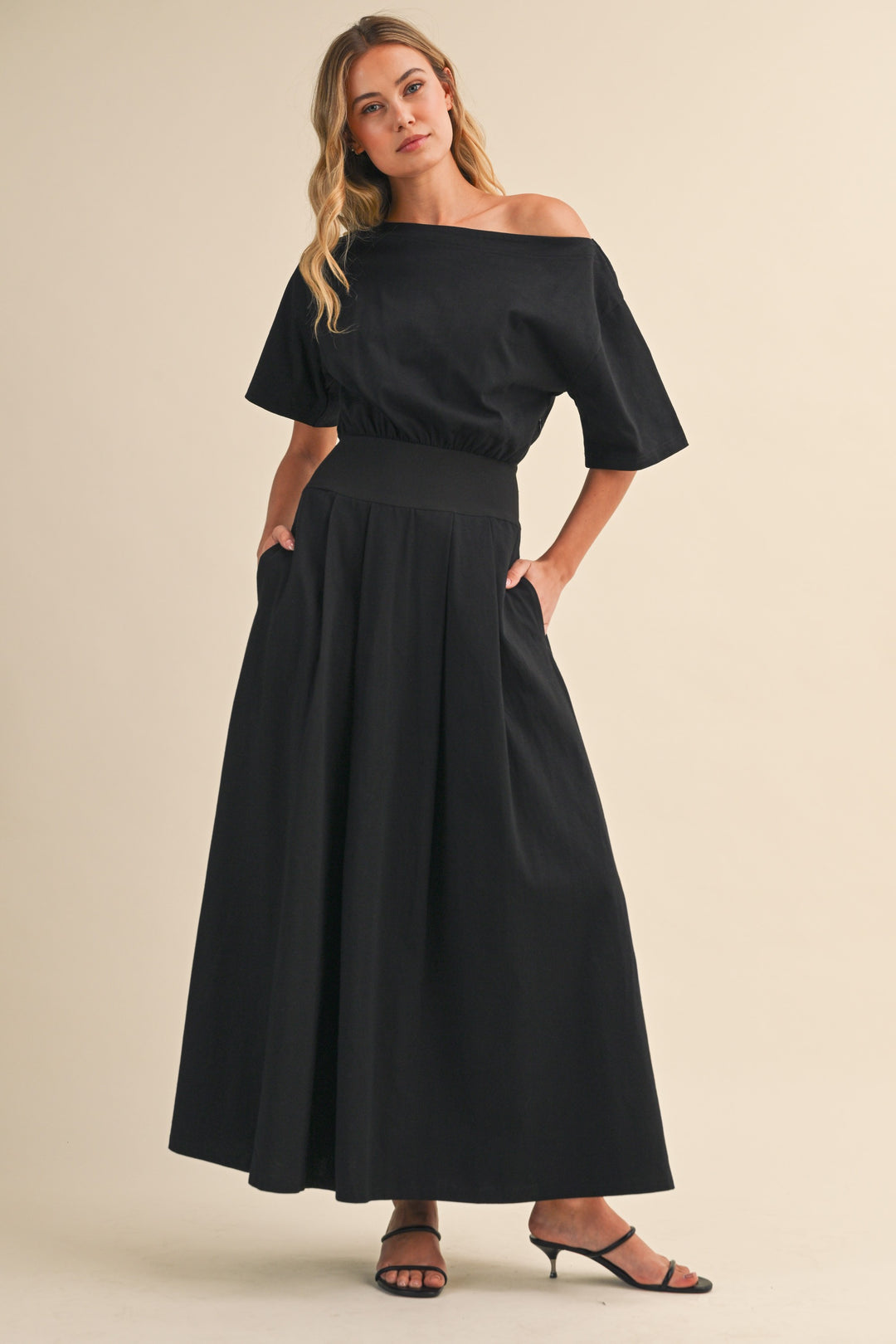 Black midi dress with boat neck and cinched waist by Klesis