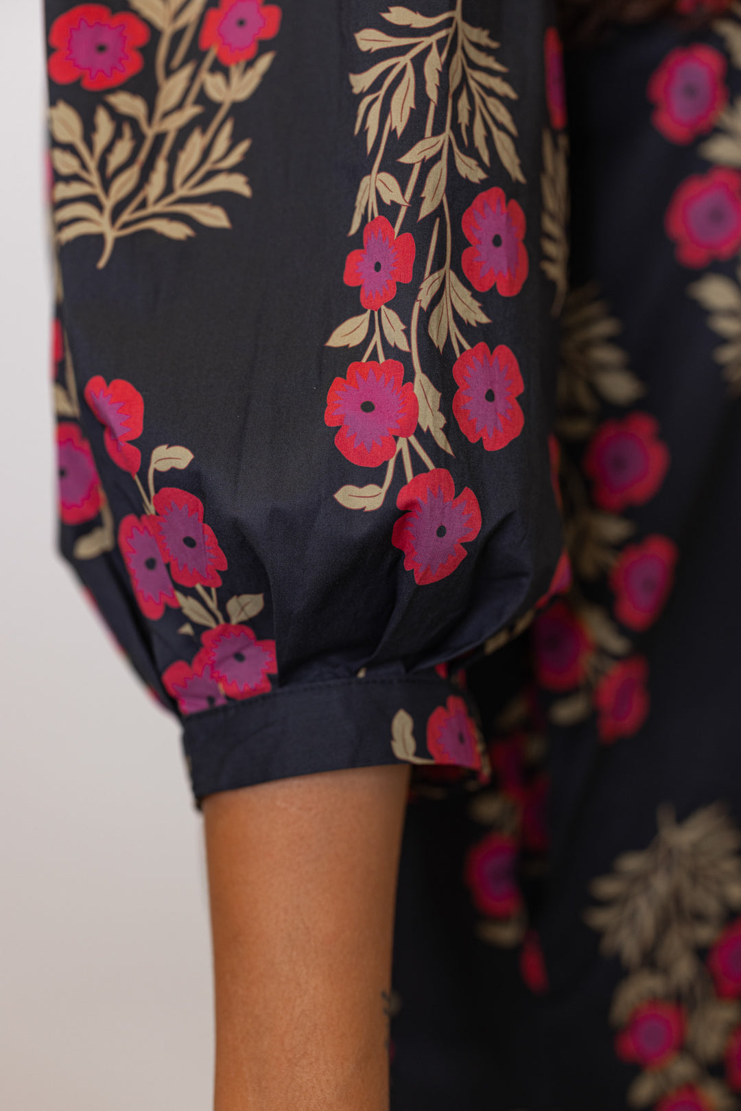 up close detail of the sleeve of black floral dress