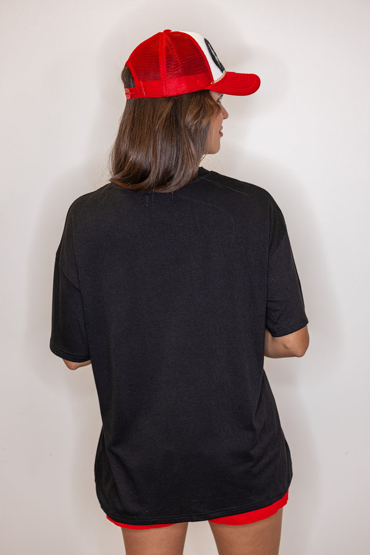 Women's black lightweight top with embossed 'Go Team' in center by Jess Lea showing up close back view