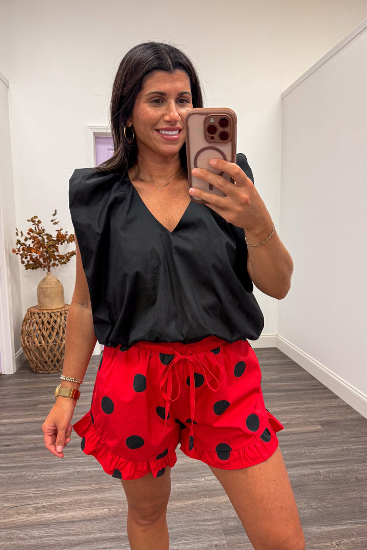 women's black dressy date night bubble hem blouse with red polka dot shorts