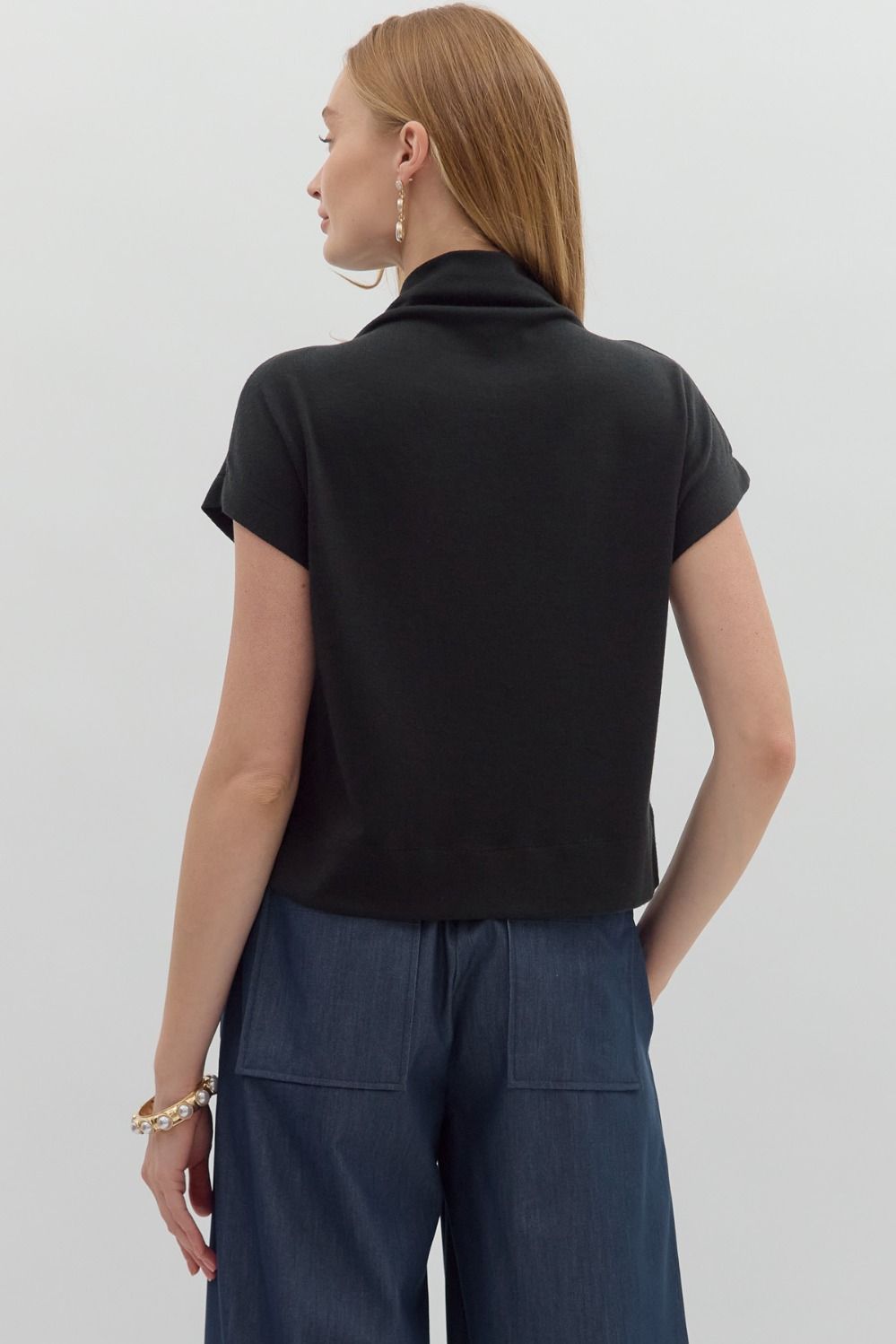 Women's black knit cropped top by Entro showing back view