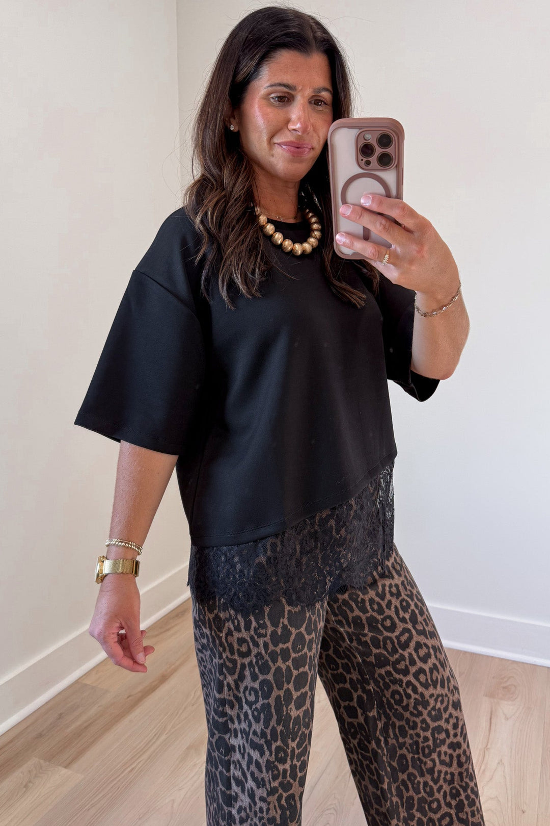 solid black asymmetrical tiered lace hem drop shoulder short sleeve crew neckline top