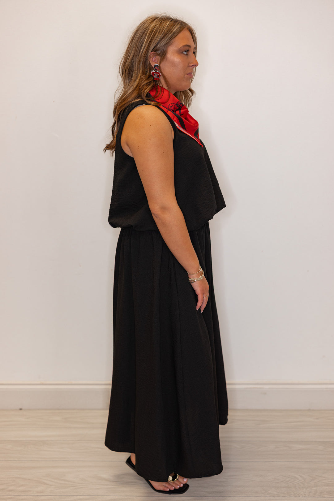 Women's black textured midi skirt with pleats by Entro showing full side view