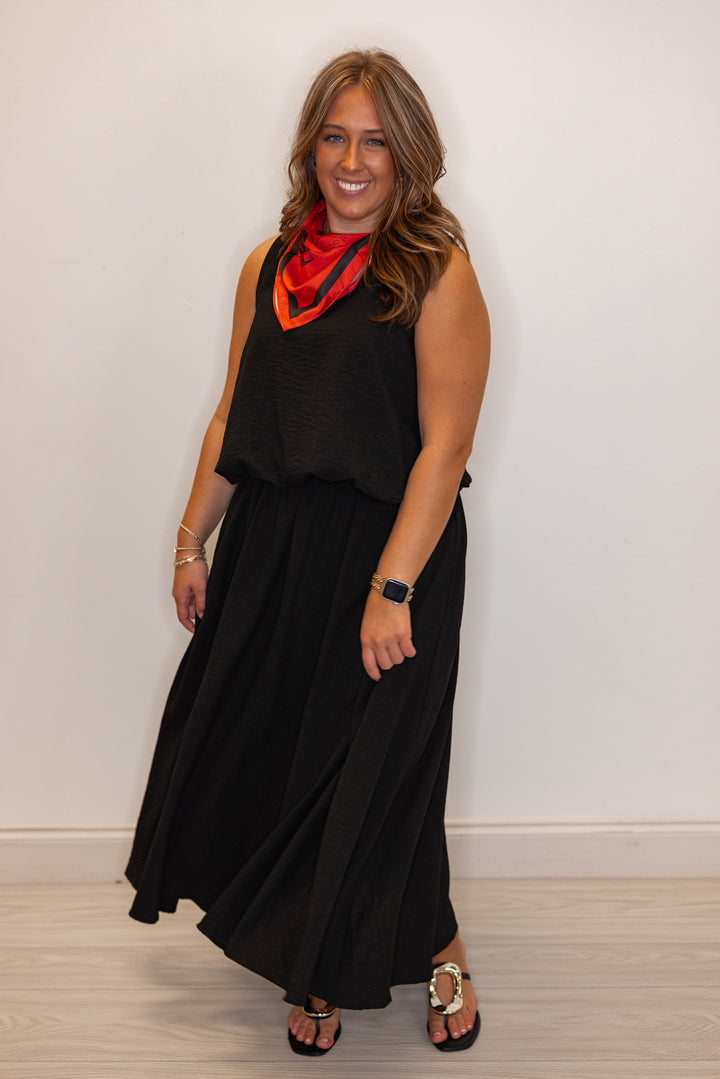 Women's black textured midi skirt with pleats by Entro shown with matching top