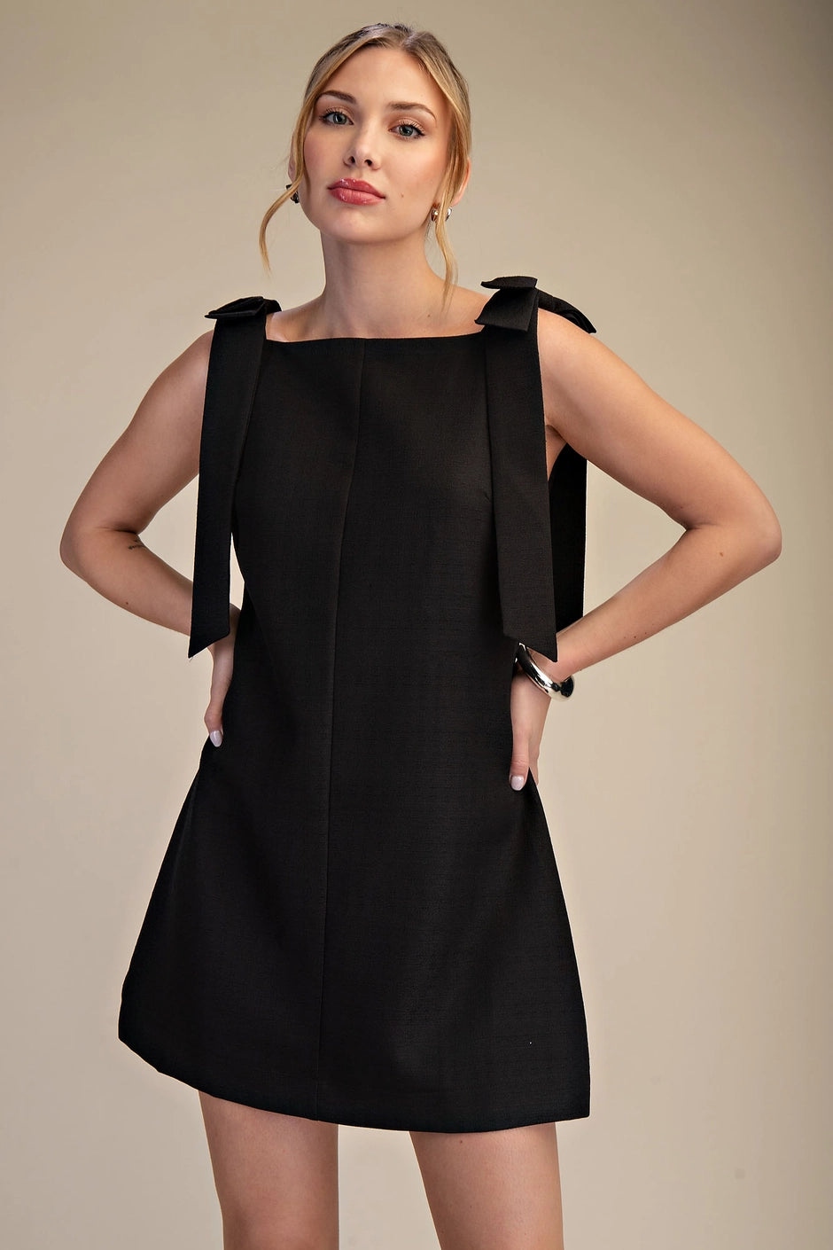 women's black mini dress with bow detailing
