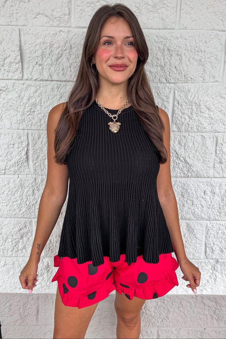 solid black crew neckline sleeveless peplum style ribbed knit top