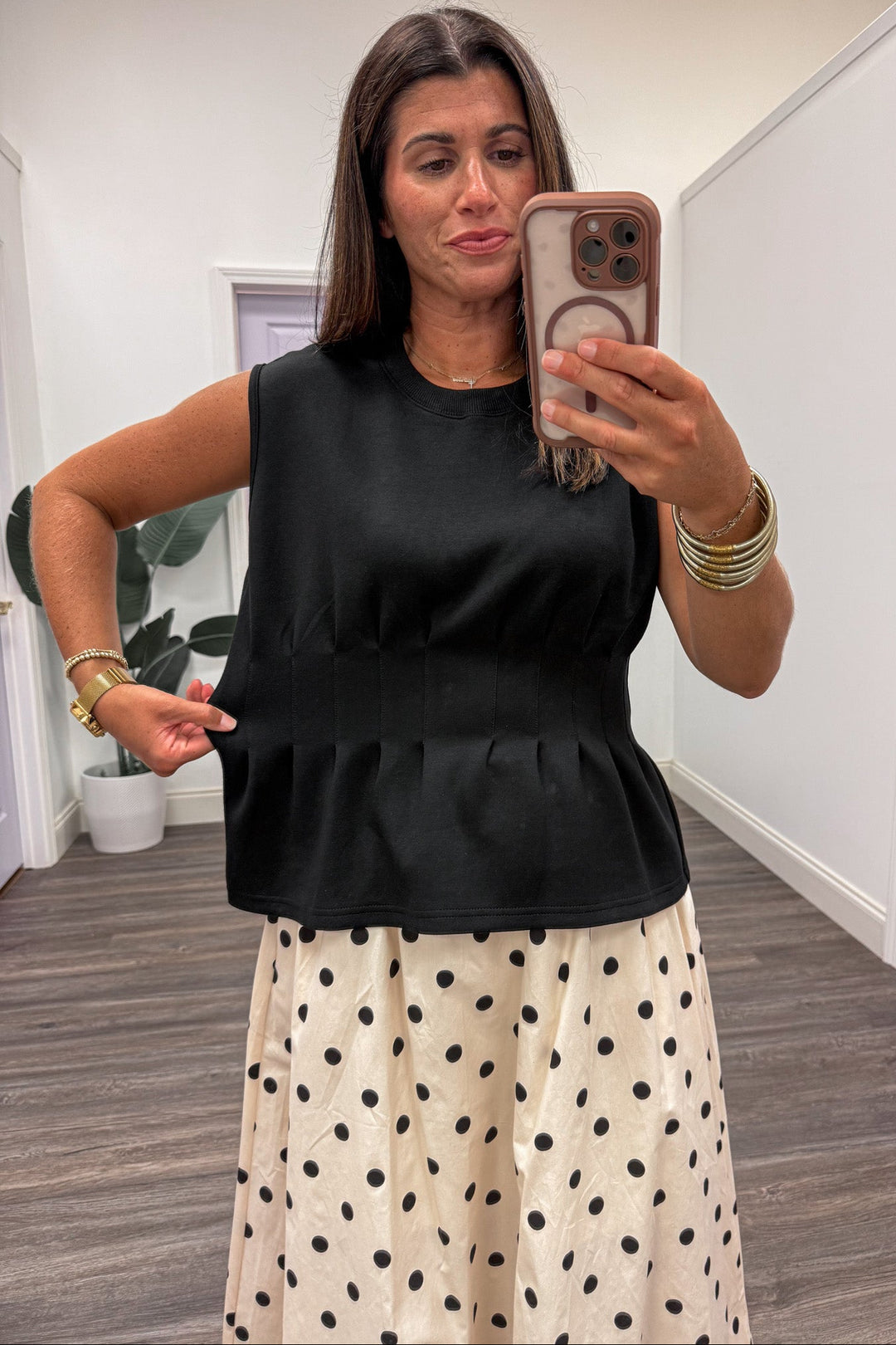 solid black crew neckline sleeveless luxe knit ruffled peplum hem top