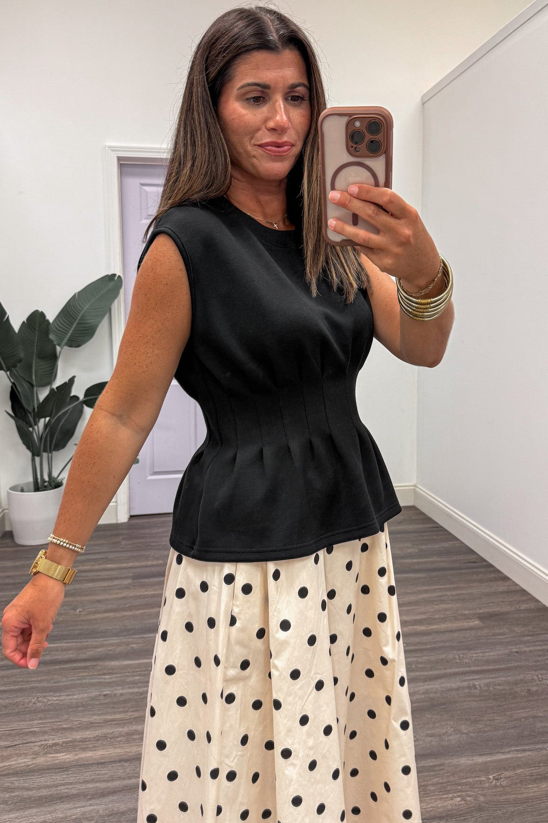 solid black crew neckline sleeveless luxe knit peplum top with pleated details