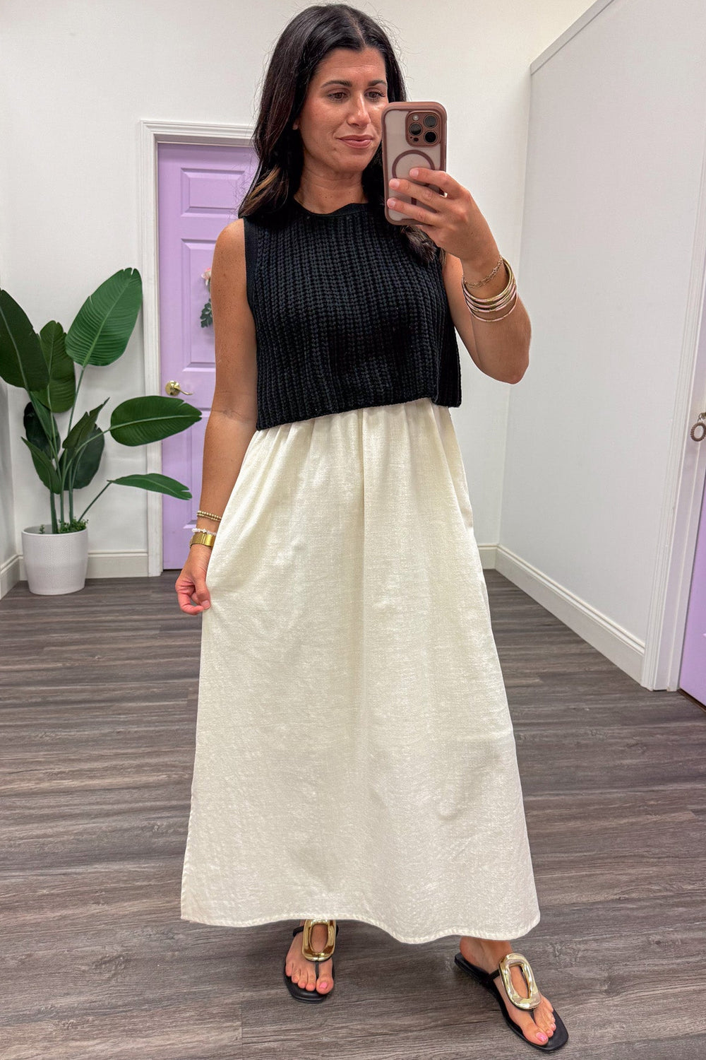 midi dress with black sleeveless sweater top and cream flowy cotton skirt