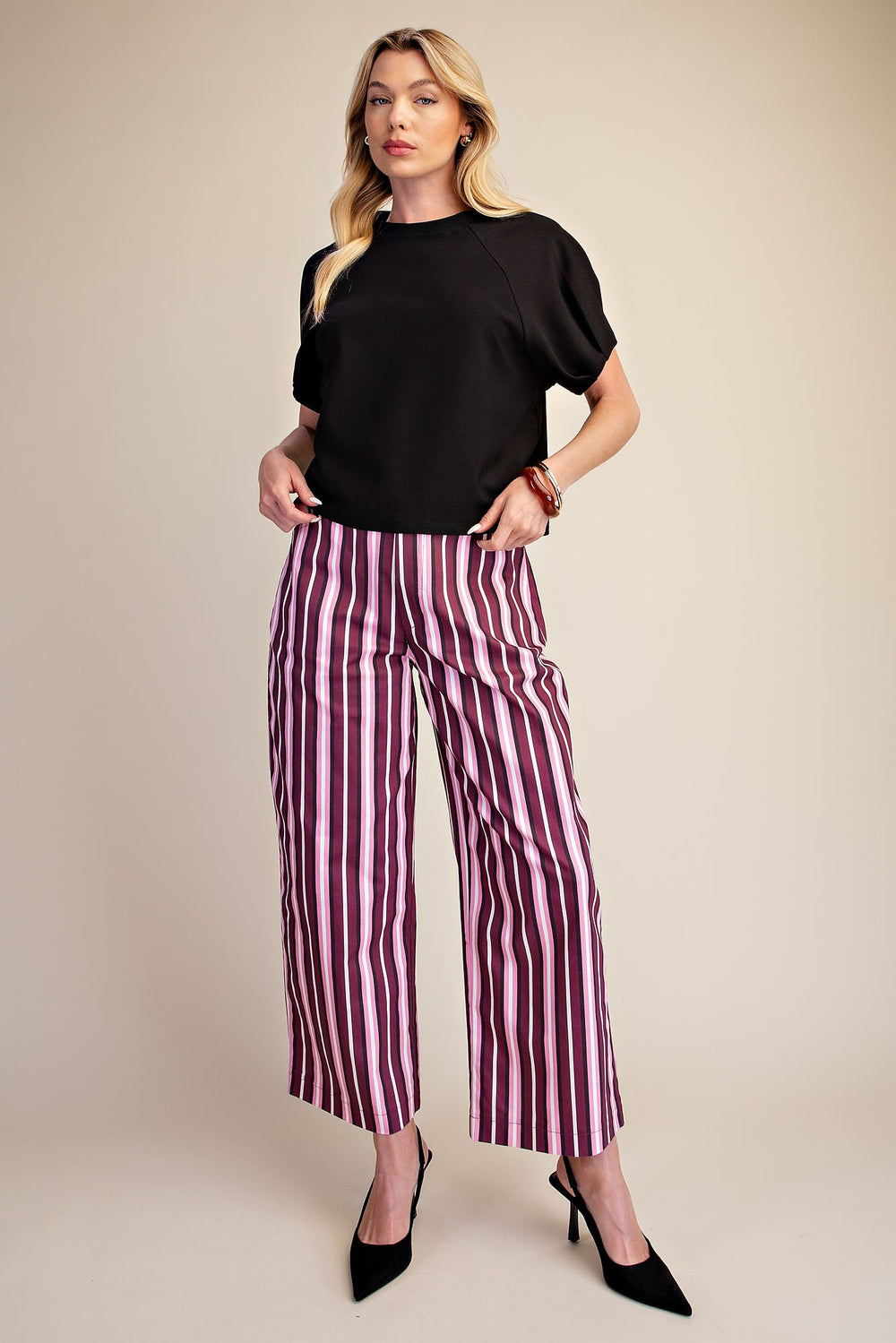 Black ribbed knit top with gathered puff sleeves in a cropped style