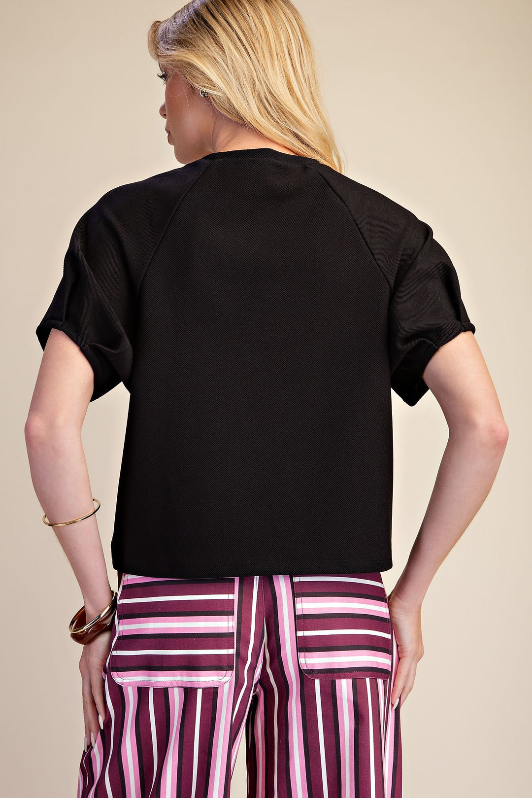 Black ribbed knit top with gathered puff sleeves in a flattering silhouette