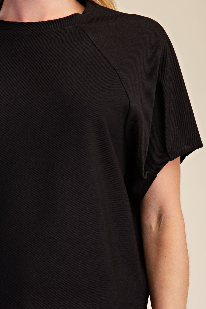 Black ribbed knit top with trendy gathered puff sleeves
