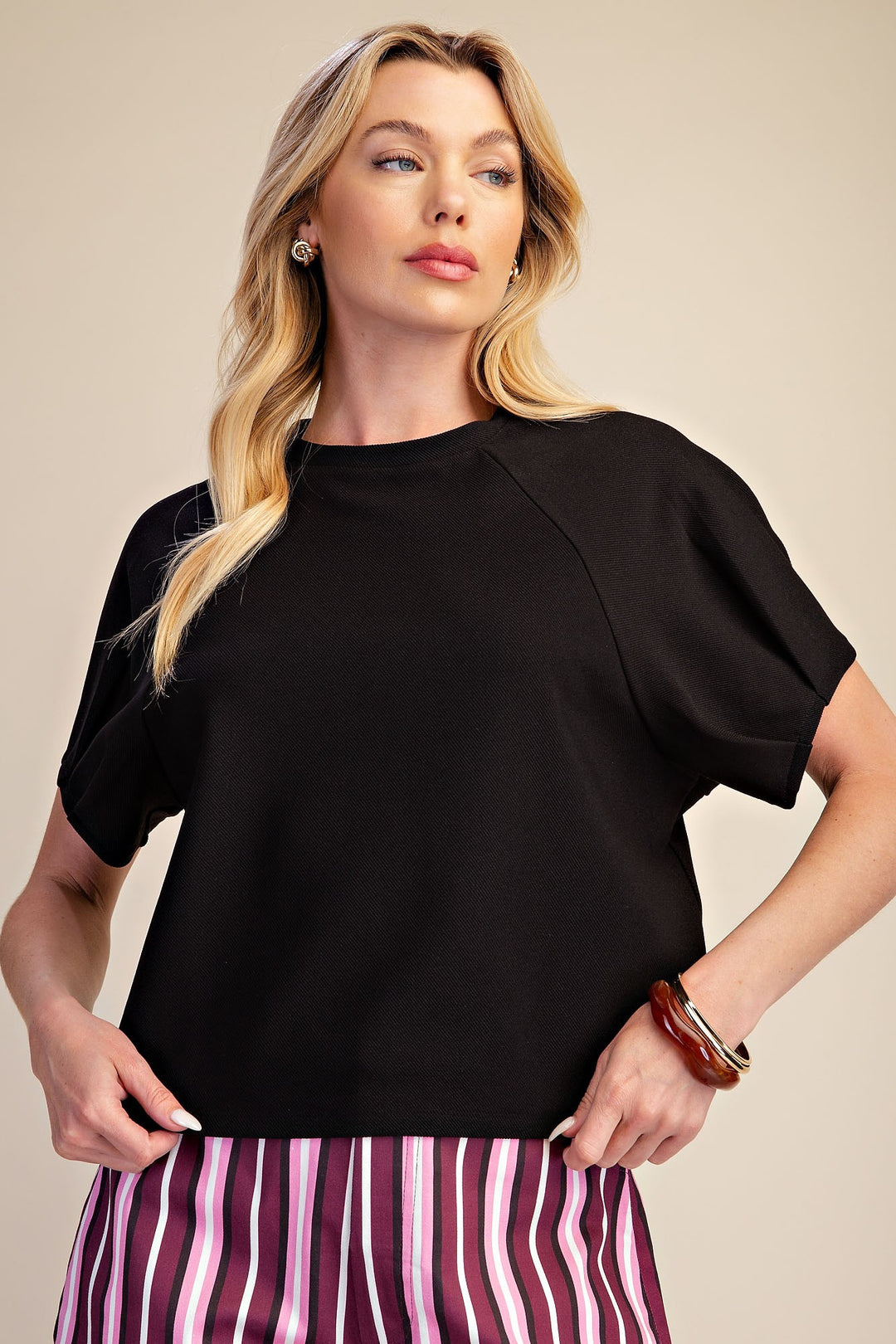 Black ribbed knit top with gathered puff sleeves and a crew neckline