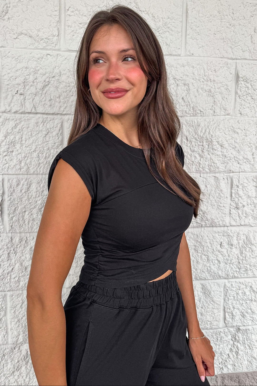 solid black crossover waist sleeveless top and jogger pants matching athleisure set