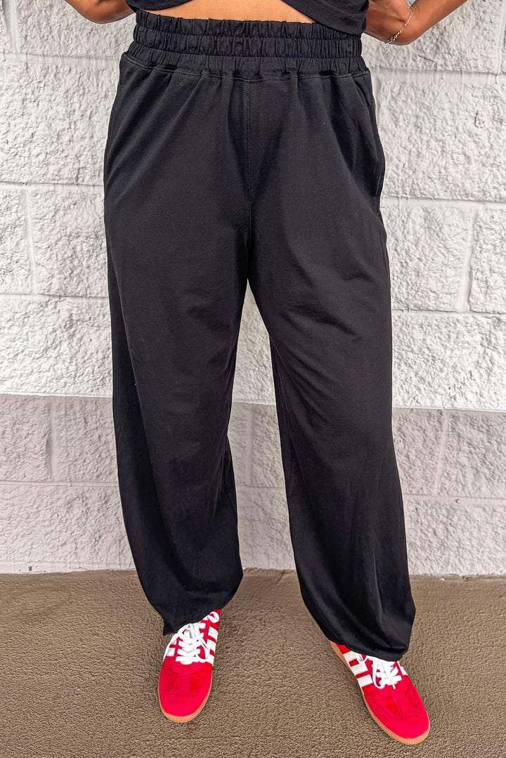 solid black sleeveless top and elastic waist jogger pants matching athleisure set
