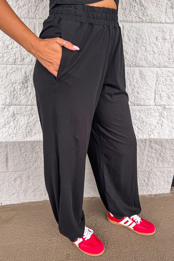 solid black sleeveless top and front pocket jogger pants matching athleisure set