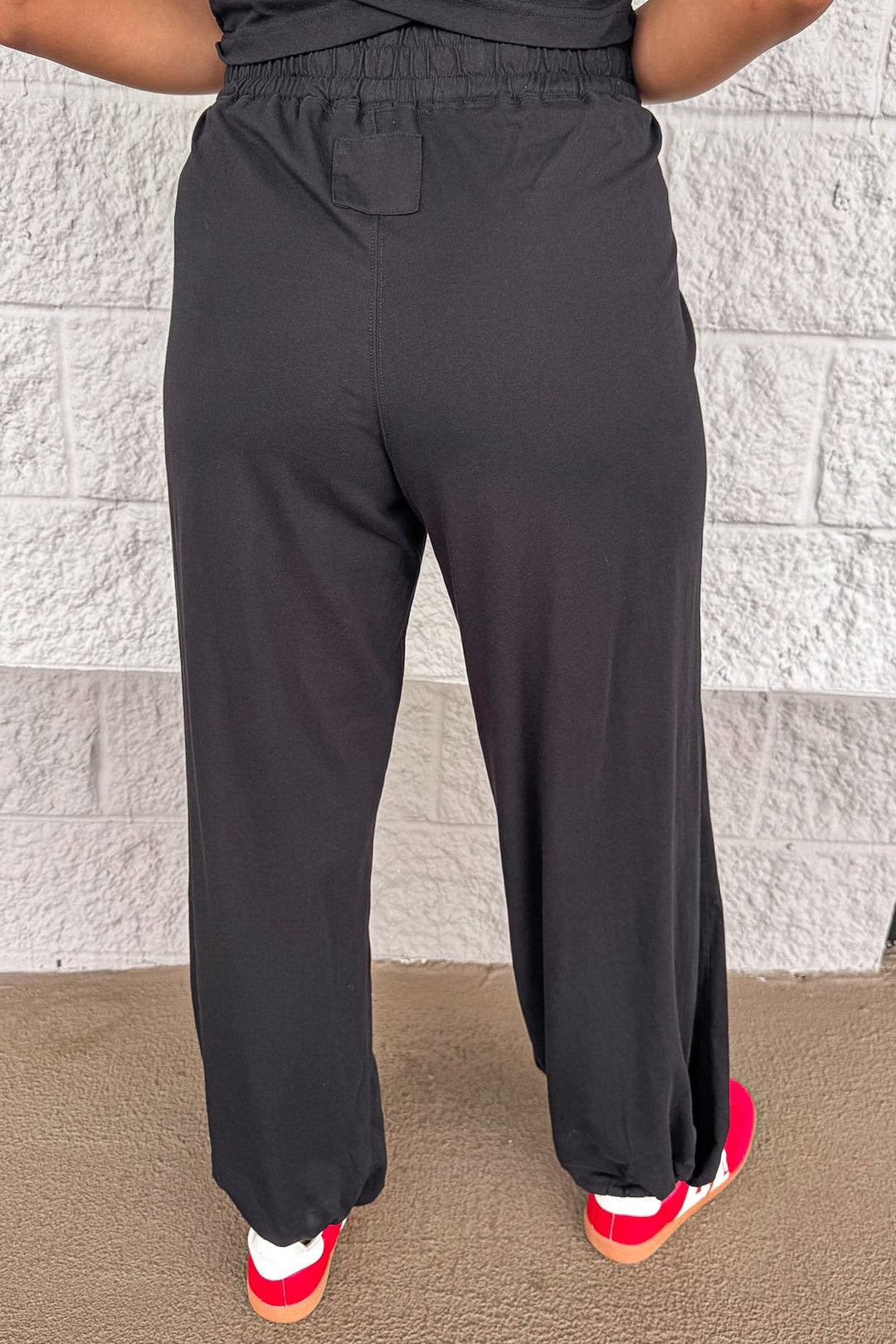 solid black sleeveless top and wide leg jogger pants matching athleisure set
