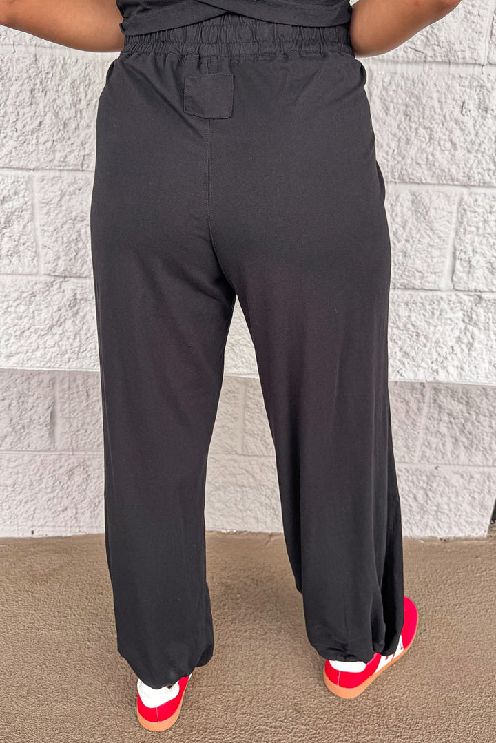 solid black sleeveless top and wide leg jogger pants matching athleisure set