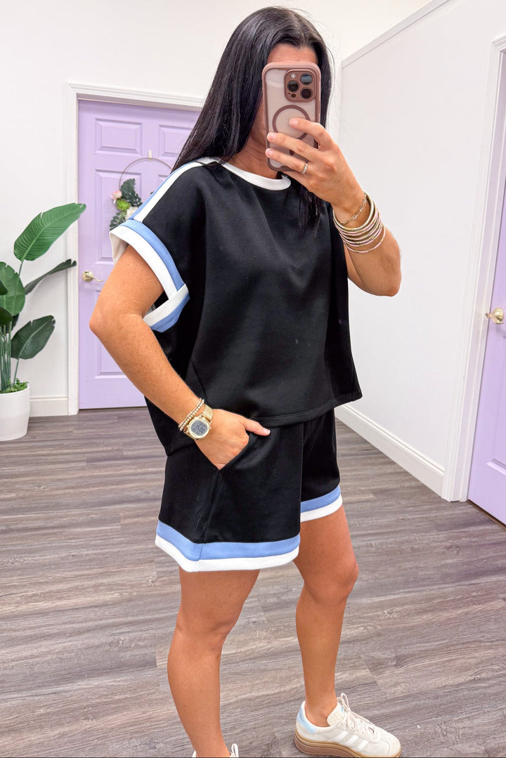white and blue trimmed scuba knit short sleeve drop shoulder black top