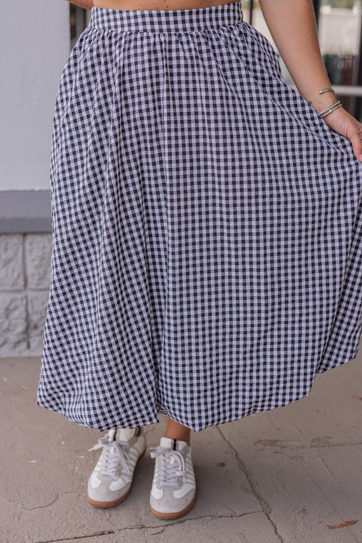 Women's black and white gingham textured midi skirt with bubble hem by Easel showing flowy fit