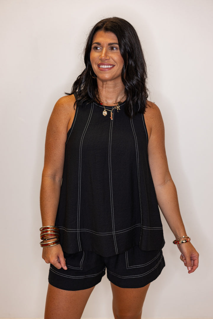 Black sleeveless top with white stitching by Entro