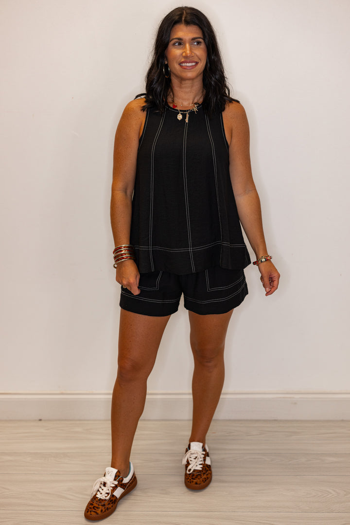 Black sleeveless top with white stitching by Entro showing full front view