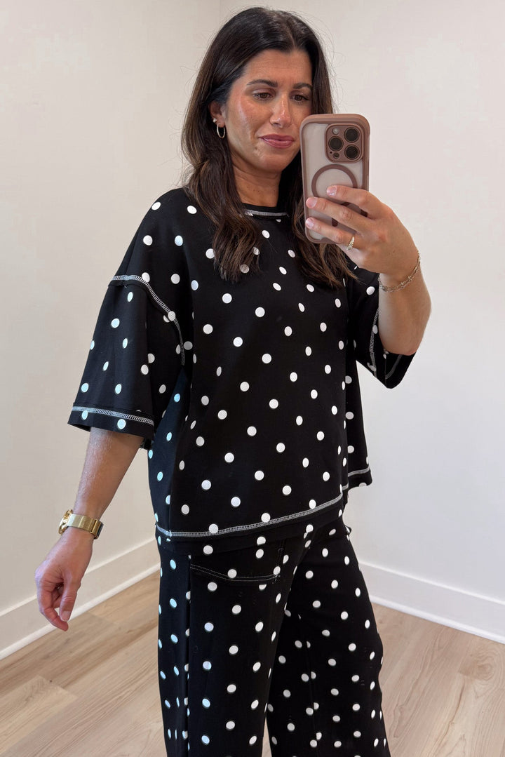 black with white polka dot print relaxed silhouette drop shoulder top and pants matching knit set