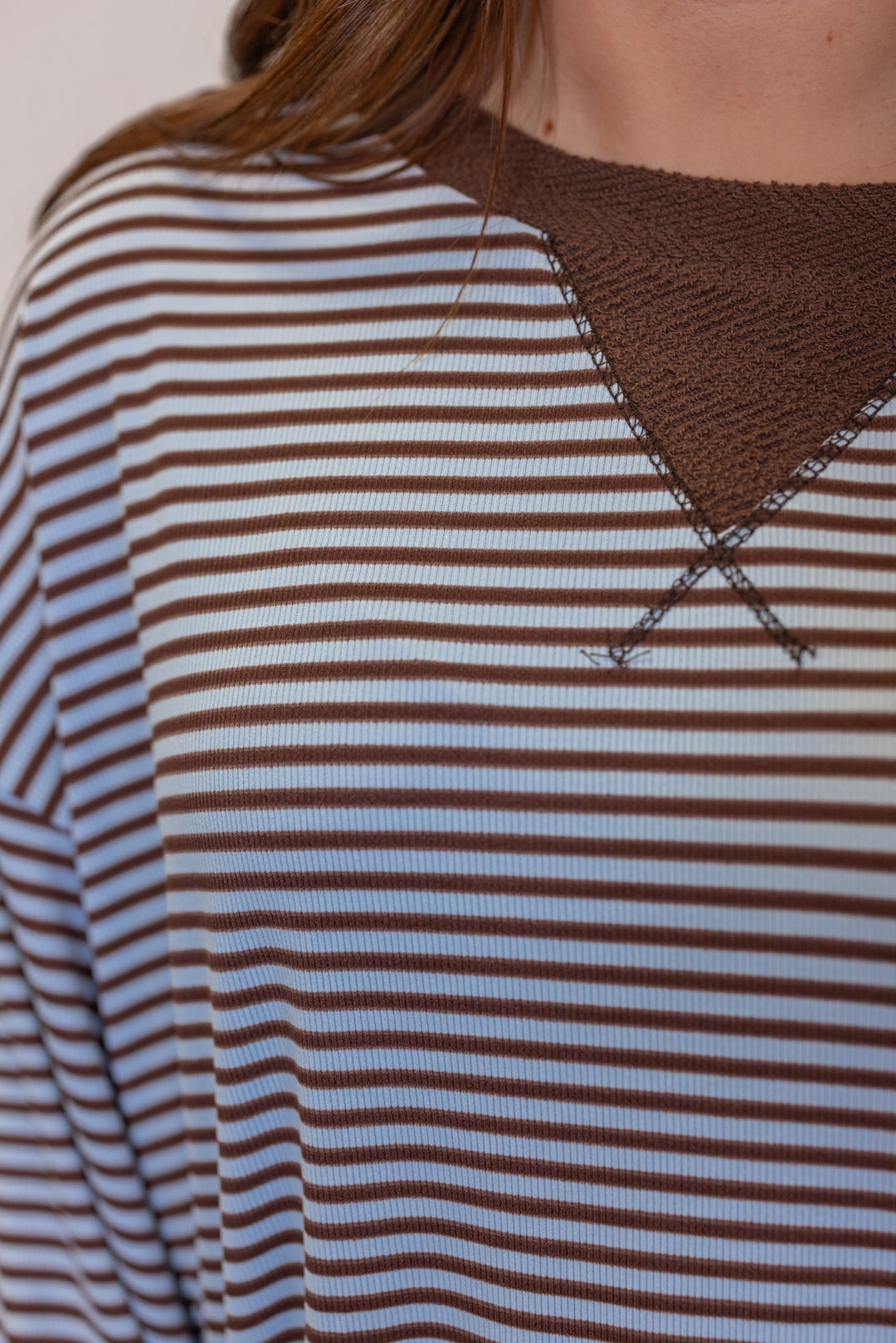 Womens light blue and brown striped knit top with contrasting terry knit trim by BucketList showing up close view of striped pattern
