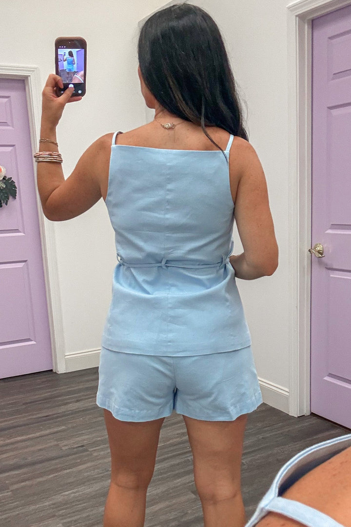 light blue sleeveless square neckline button front belted waist vest style top