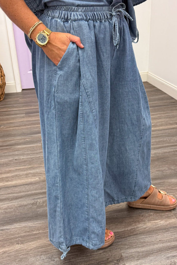 washed blue denim wide leg drawstring ankle jogger pants with front pockets