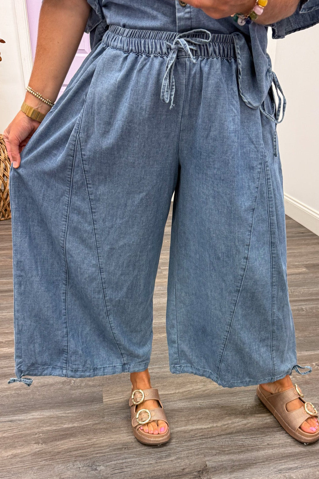 washed blue denim wide leg drawstring ankle jogger pants with reverse seam details