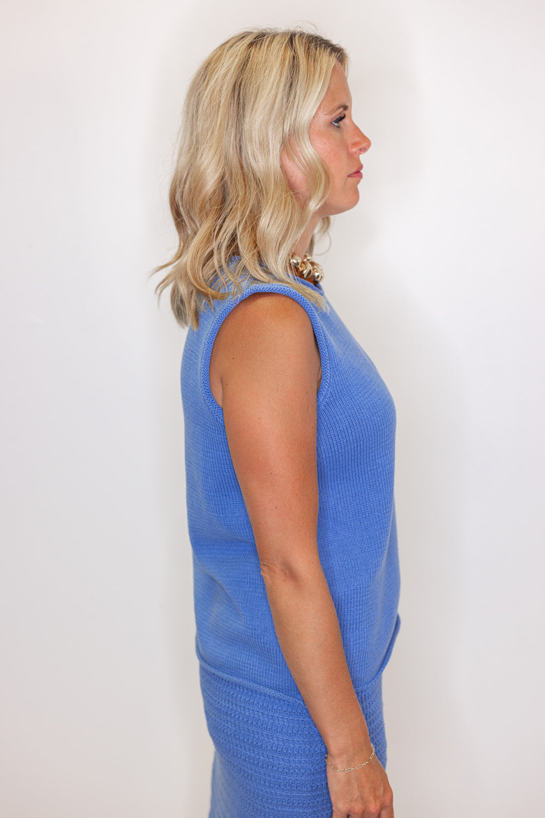 Women's blue sweater knit maxi skirt with matching sleeveless contrasting knit top by Wishlist showing up close side view of top