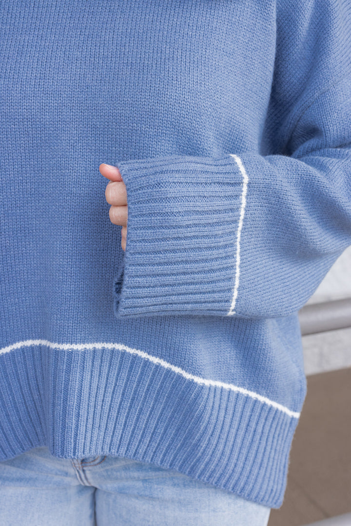 Women's blue knit sweater with cream trim details by Wishlist showing ribbed details throughout