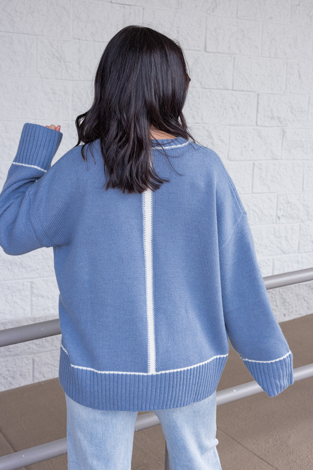 Women's blue knit sweater with cream trim details by Wishlist showing up close back view
