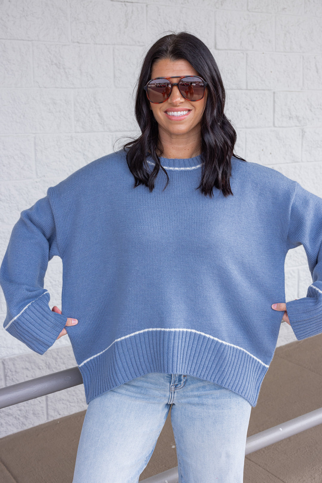 Women's blue knit sweater with cream trim details by Wishlist showing relaxed fit