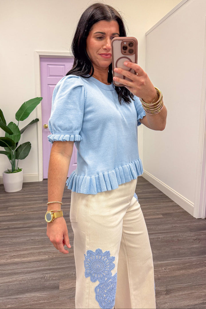 Baby blue ruffle trim slightly cropped knit top side view