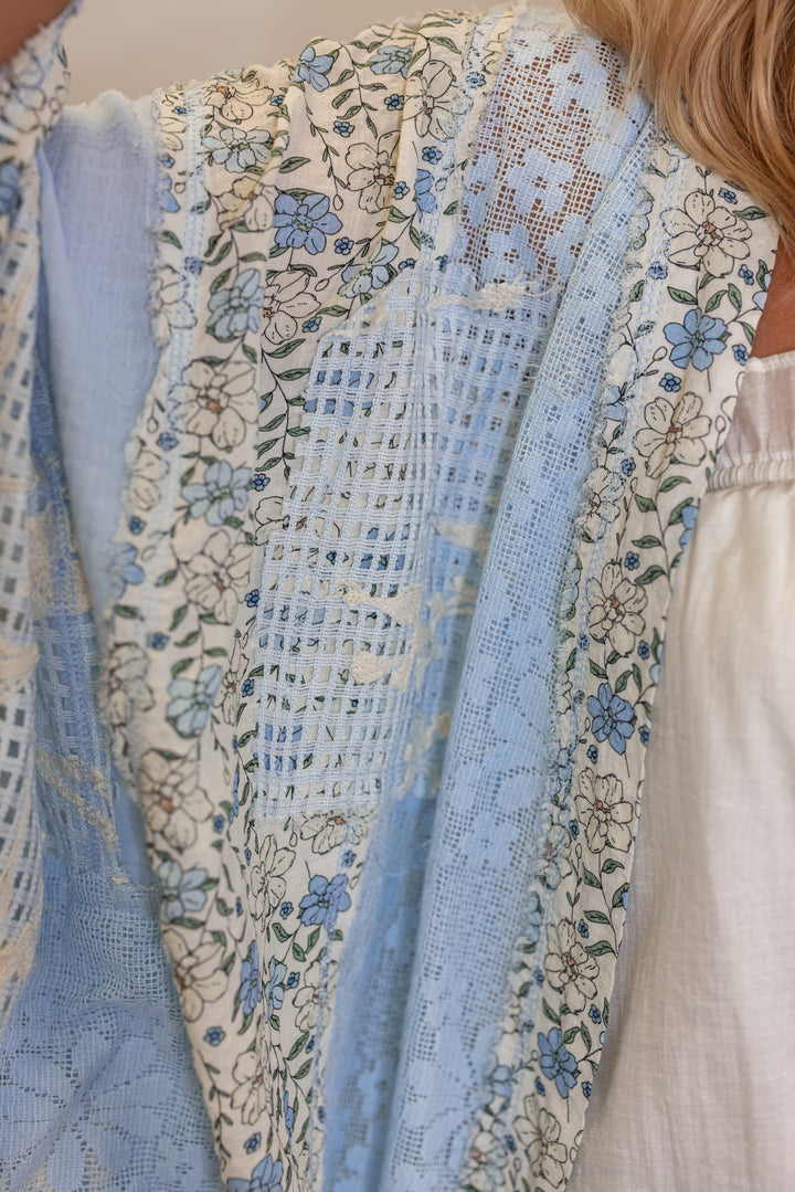 Women's sky blue gauze cardigan top with floral print and floral lace patchwork by POL showing floral and lace detail