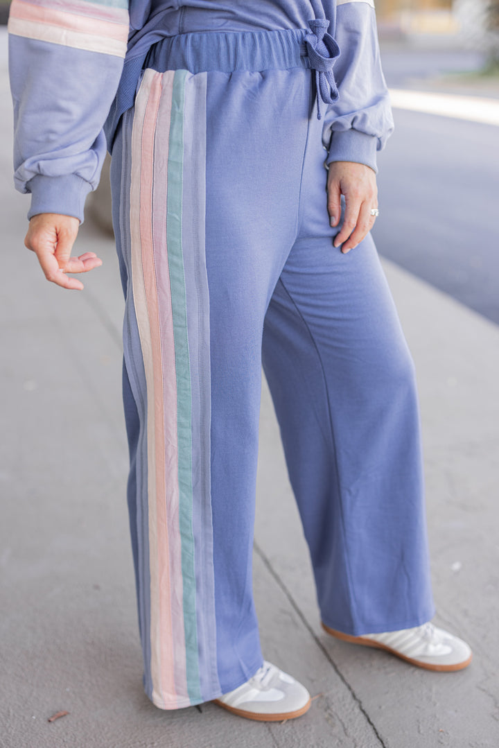 Women's knit top and matching pants set in blue denim shade with stripe trim details by Very J showing side view of pants