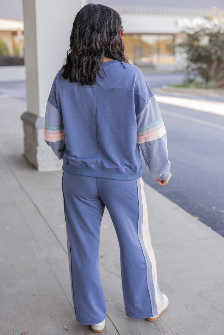 Women's knit top and matching pants set in blue denim shade with stripe trim details by Very J showing full back view