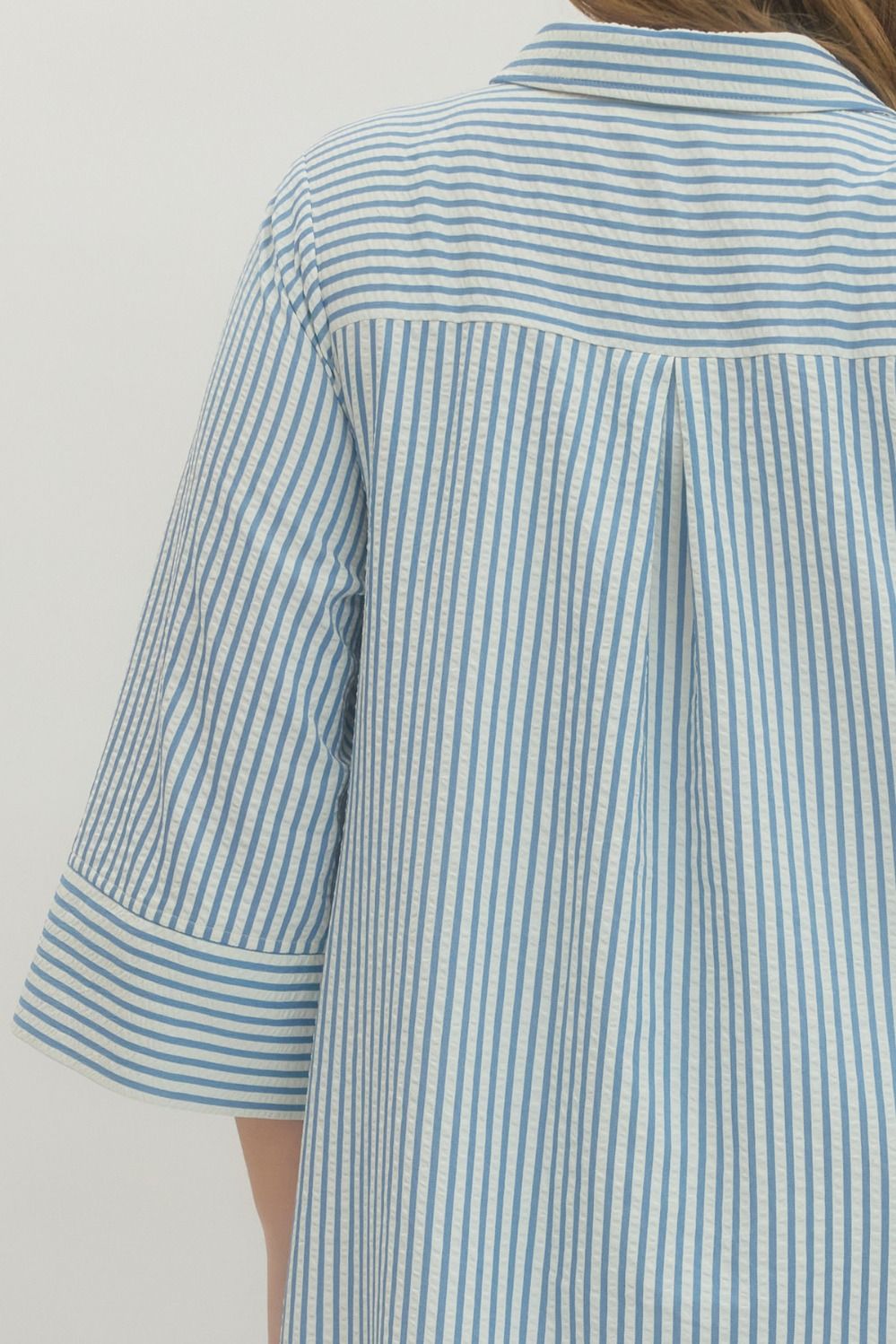 Women's plus size striped blue maxi dress by Entro showing pleated details in back