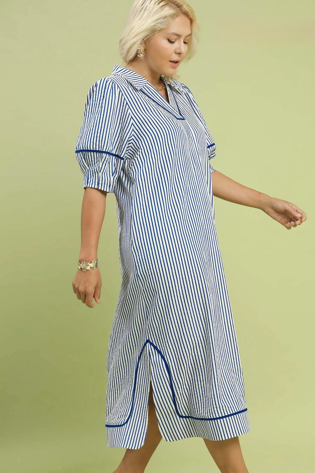 Women's Umgee textured blue and white striped midi dress with navy trim in plus size showing dress movement.