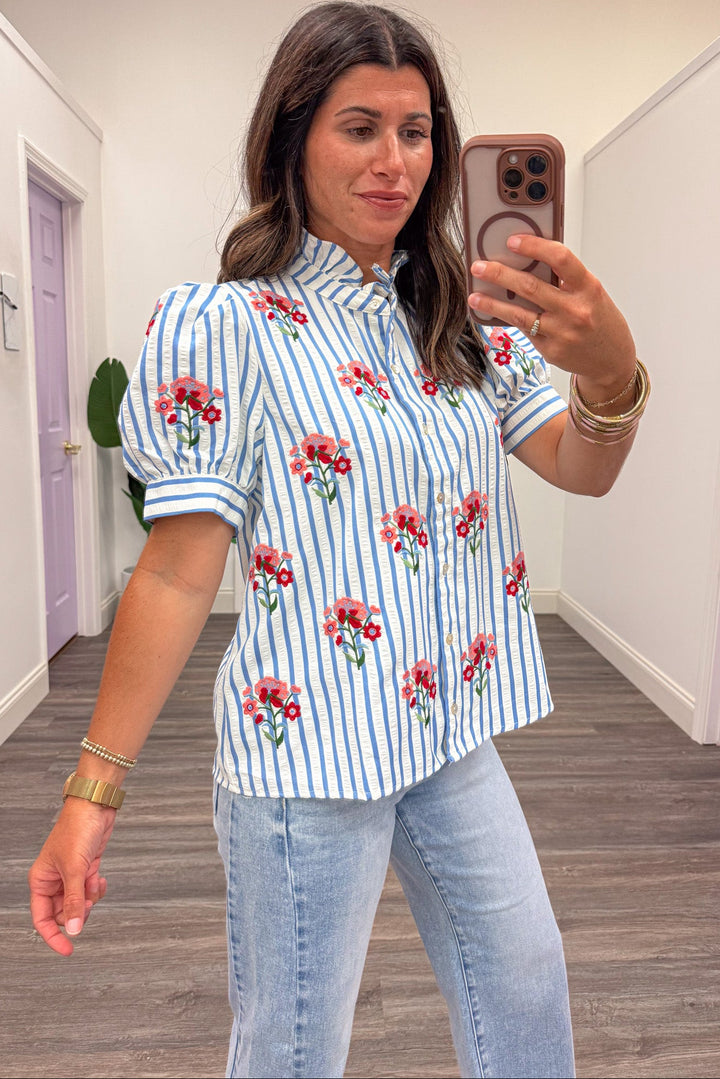 blue and white striped with red and pink embroidered flowers ruffle trimmed mock neck button front top