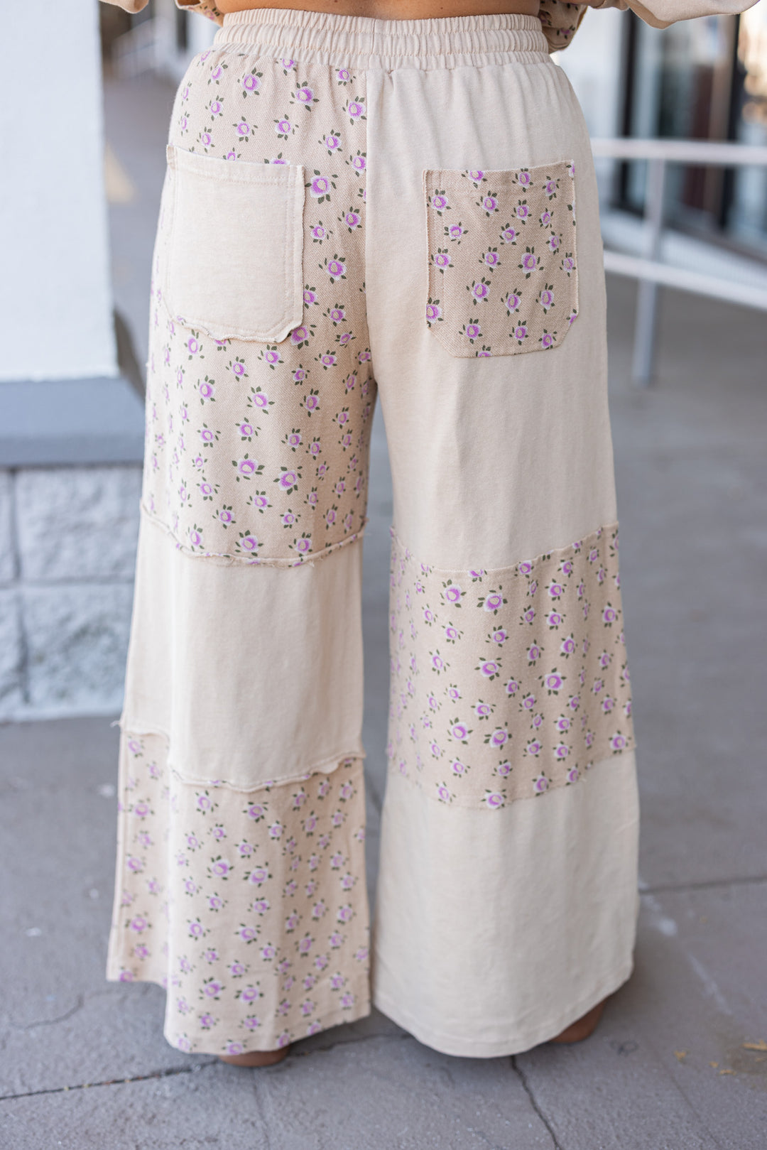 Women's washed khaki terry knit wide leg pants with pink floral print colorblock by Easel showing up close back view